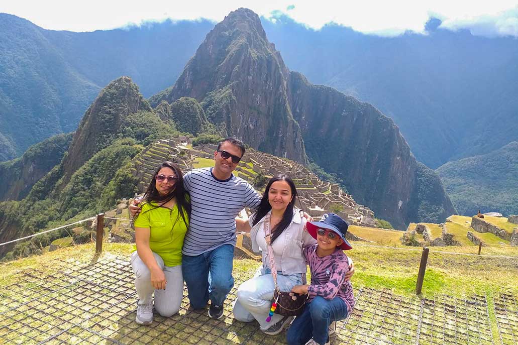 Tourist family visiting Machu Picchu archaeological site