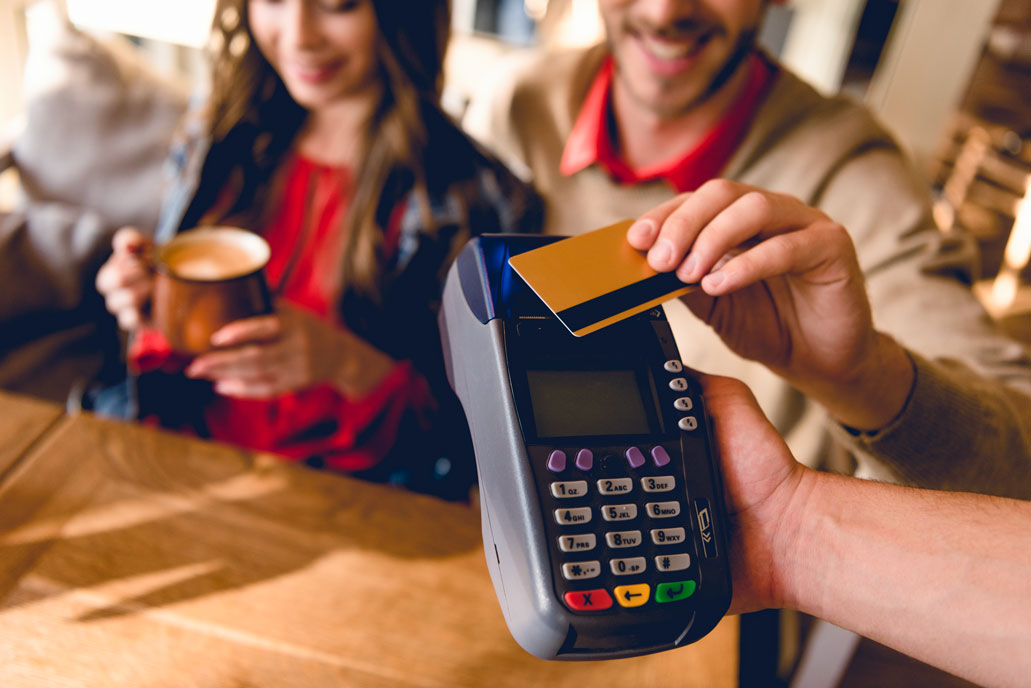 Tourist paying by card in a cafe