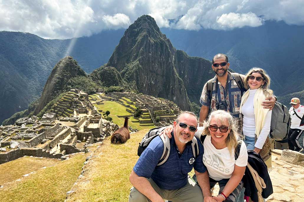 Tourist family visiting Machu Picchu archaeological site